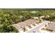An aerial view of houses with mature trees and powerlines surrounding the properties at 1800 Little Bird Ct, Sarasota, FL 34235