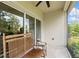 Screened back porch with ceiling fan, and sliding glass door entrance to interior at 1800 Little Bird Ct, Sarasota, FL 34235