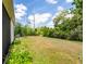 Home exterior showcasing a spacious backyard with privacy foliage at 1800 Little Bird Ct, Sarasota, FL 34235