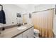 Bathroom featuring a white vanity, neutral countertop, and a shower with a striped curtain at 1800 Little Bird Ct, Sarasota, FL 34235