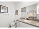 Cozy bathroom featuring a white vanity, granite countertop, and neutral color scheme at 1800 Little Bird Ct, Sarasota, FL 34235
