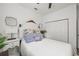 Relaxing bedroom with white bedding, hardwood floors, and closet for storage at 1800 Little Bird Ct, Sarasota, FL 34235