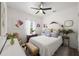 Cozy bedroom featuring floral bedding, bright natural light, and hardwood floors at 1800 Little Bird Ct, Sarasota, FL 34235