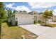 Well-maintained single-Gathering home with an attached garage, green grass, and landscaping at 1800 Little Bird Ct, Sarasota, FL 34235