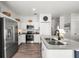 Well-lit kitchen with modern appliances, island, and white cabinets at 1800 Little Bird Ct, Sarasota, FL 34235