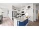 Modern kitchen with stainless steel appliances, an island, and white cabinetry at 1800 Little Bird Ct, Sarasota, FL 34235