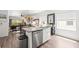 Open concept kitchen with island including stainless steel dishwasher and sink at 1800 Little Bird Ct, Sarasota, FL 34235