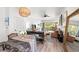 Open concept living and dining area with stylish decor, wood floors, and ample natural light at 1800 Little Bird Ct, Sarasota, FL 34235