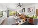 Well-lit living room showcasing wood floors, stylish furniture, and a sliding glass door to the outdoors at 1800 Little Bird Ct, Sarasota, FL 34235