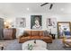 Comfortable living room with leather sofa, contemporary art, and open floor plan at 1800 Little Bird Ct, Sarasota, FL 34235