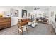 Elegant living room with an open floor plan, tan leather sofa, and hardwood floors at 1800 Little Bird Ct, Sarasota, FL 34235