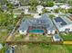 A high angle showing a house with solar panels and a pool inside a screen enclosure at 1828 Mova St, Sarasota, FL 34231