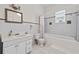 Cozy bathroom featuring a shower-tub combo and a vanity with a decorative mirror at 1828 Mova St, Sarasota, FL 34231