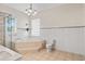 Large bathroom featuring a garden tub, glass block window and tile flooring at 1828 Mova St, Sarasota, FL 34231