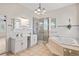 Spacious bathroom featuring double sinks, shower, soaking tub, and modern fixtures at 1828 Mova St, Sarasota, FL 34231