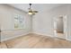 Bedroom with wooden floors, ceiling fan, and large window at 1828 Mova St, Sarasota, FL 34231
