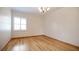 Bright bedroom featuring hardwood floors, crown molding and a large window at 1828 Mova St, Sarasota, FL 34231