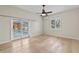 This bedroom features light wood floors, fan and sliding glass doors overlooking a swimming pool at 1828 Mova St, Sarasota, FL 34231