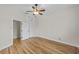 Bright bedroom featuring hardwood floors, ceiling fan, and a closet for ample storage at 1828 Mova St, Sarasota, FL 34231