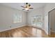 Spacious bedroom featuring hardwood floors, ceiling fan and sliding glass door to pool area at 1828 Mova St, Sarasota, FL 34231