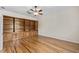 Bedroom boasting custom built-in shelving, hardwood floors, and ceiling fan at 1828 Mova St, Sarasota, FL 34231