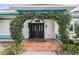 Inviting home entrance framed by greenery, featuring double doors and a brick-paved porch at 1828 Mova St, Sarasota, FL 34231