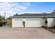 Spacious three-car garage with brick-paved driveway and mature landscaping at 1828 Mova St, Sarasota, FL 34231