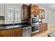 Stainless ovens, dishwasher, sink and wood cabinets with granite countertops are the focal point in the kitchen at 1828 Mova St, Sarasota, FL 34231