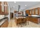 Kitchen featuring wooden cabinets, granite counters, stainless appliances, and island with barstool seating at 1828 Mova St, Sarasota, FL 34231