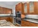 Kitchen area features a sink, dishwasher, ovens, and wood cabinets with granite countertops at 1828 Mova St, Sarasota, FL 34231
