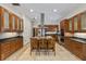 An open kitchen with stainless steel appliances, wooden cabinets, granite countertops, and an island with seating at 1828 Mova St, Sarasota, FL 34231