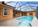 Enclosed pool with brick pavers and multiple access points to the house at 1828 Mova St, Sarasota, FL 34231