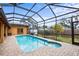A charming screened-in pool with a brick patio, blending indoor comfort with outdoor delight for perfect relaxation at 1828 Mova St, Sarasota, FL 34231