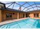 Enclosed pool with brick pavers, chimney and multiple access points to the house at 1828 Mova St, Sarasota, FL 34231
