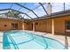 Enclosed pool with brick pavers and multiple access points to the house and hot tub at 1828 Mova St, Sarasota, FL 34231