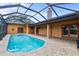 Enclosed pool with brick pavers, chimney and multiple access points at 1828 Mova St, Sarasota, FL 34231