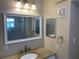 Bathroom with a granite countertop, a large mirror and a three light vanity fixture at 205 46Th Avenue W Ter # 425, Bradenton, FL 34207