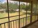 Screened porch provides relaxing views of landscaped grounds with mature trees and tennis court at 205 46Th Avenue W Ter # 425, Bradenton, FL 34207