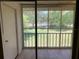 View from screened porch showing green grounds, mature trees, and recreational tennis courts at 205 46Th Avenue W Ter # 425, Bradenton, FL 34207