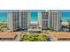 An aerial view showcasing a beachfront condominium, lush landscaping, and convenient parking at 2301 Gulf Of Mexico Dr # 26N, Longboat Key, FL 34228