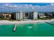 Stunning aerial view of beachfront condos with a pristine sandy beach and turquoise ocean waters at 2301 Gulf Of Mexico Dr # 26N, Longboat Key, FL 34228