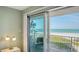 Balcony view with seating overlooks the beach and ocean, accessible from a bedroom at 2301 Gulf Of Mexico Dr # 26N, Longboat Key, FL 34228