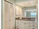 Bathroom vanity with granite countertop, ample storage, and a view towards the bedroom and ocean at 2301 Gulf Of Mexico Dr # 26N, Longboat Key, FL 34228