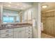 Bathroom with granite vanity, large mirror, and shower view to the bedroom and ocean at 2301 Gulf Of Mexico Dr # 26N, Longboat Key, FL 34228