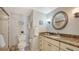 Traditional bathroom with granite countertops, decorative mirror, and shower with glass door at 2301 Gulf Of Mexico Dr # 26N, Longboat Key, FL 34228