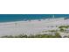 Sandy white beach with lounge chairs and beachgoers at 2301 Gulf Of Mexico Dr # 26N, Longboat Key, FL 34228