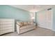 This bedroom features a light blue wall, tile floors, and an off-white sofa at 2301 Gulf Of Mexico Dr # 26N, Longboat Key, FL 34228