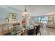 A dining room opens to the living room with ocean views in the background at 2301 Gulf Of Mexico Dr # 26N, Longboat Key, FL 34228