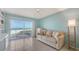 A bright living room includes ocean views through sliding glass doors to a balcony at 2301 Gulf Of Mexico Dr # 26N, Longboat Key, FL 34228