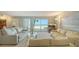 Cozy living room with balcony access offering serene views of the beach and turquoise ocean at 2301 Gulf Of Mexico Dr # 26N, Longboat Key, FL 34228